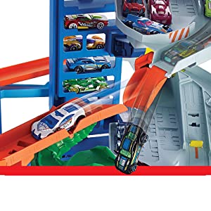 Hot Wheels City Super Dino Robot Garage avec T-Rex, pour contenir jusqu’??100 petites voitures