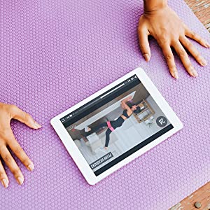Booty resistant bands in workout video on iPad, showing resistance bands women use